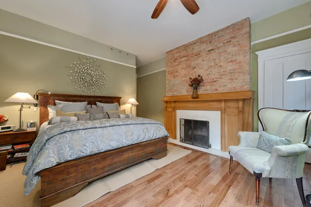 a bedroom with bed and a fireplace