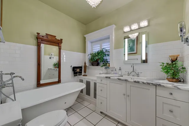 a bathroom with a double vanity sink mirror and toilet
