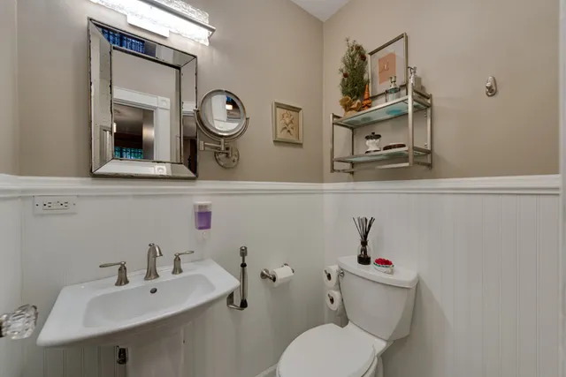 a bathroom with a toilet sink and mirror