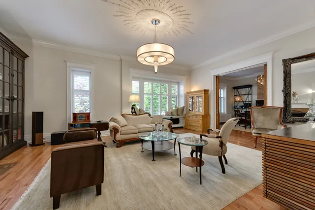 a living room with furniture a fireplace and a large mirror