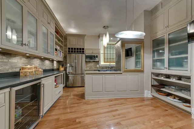 a kitchen with stainless steel appliances a stove and more cabinets