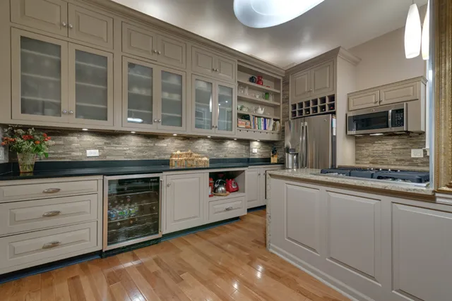a kitchen with stainless steel appliances granite countertop a stove and cabinets