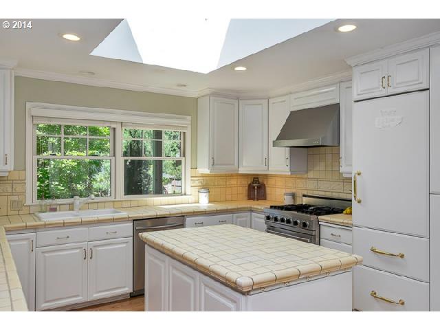 3700 Southwest 48th Place Portland, OR 97221 - Photo 2 of 16 a kitchen with stainless steel appliances granite countertop a sink stove and refrigerator