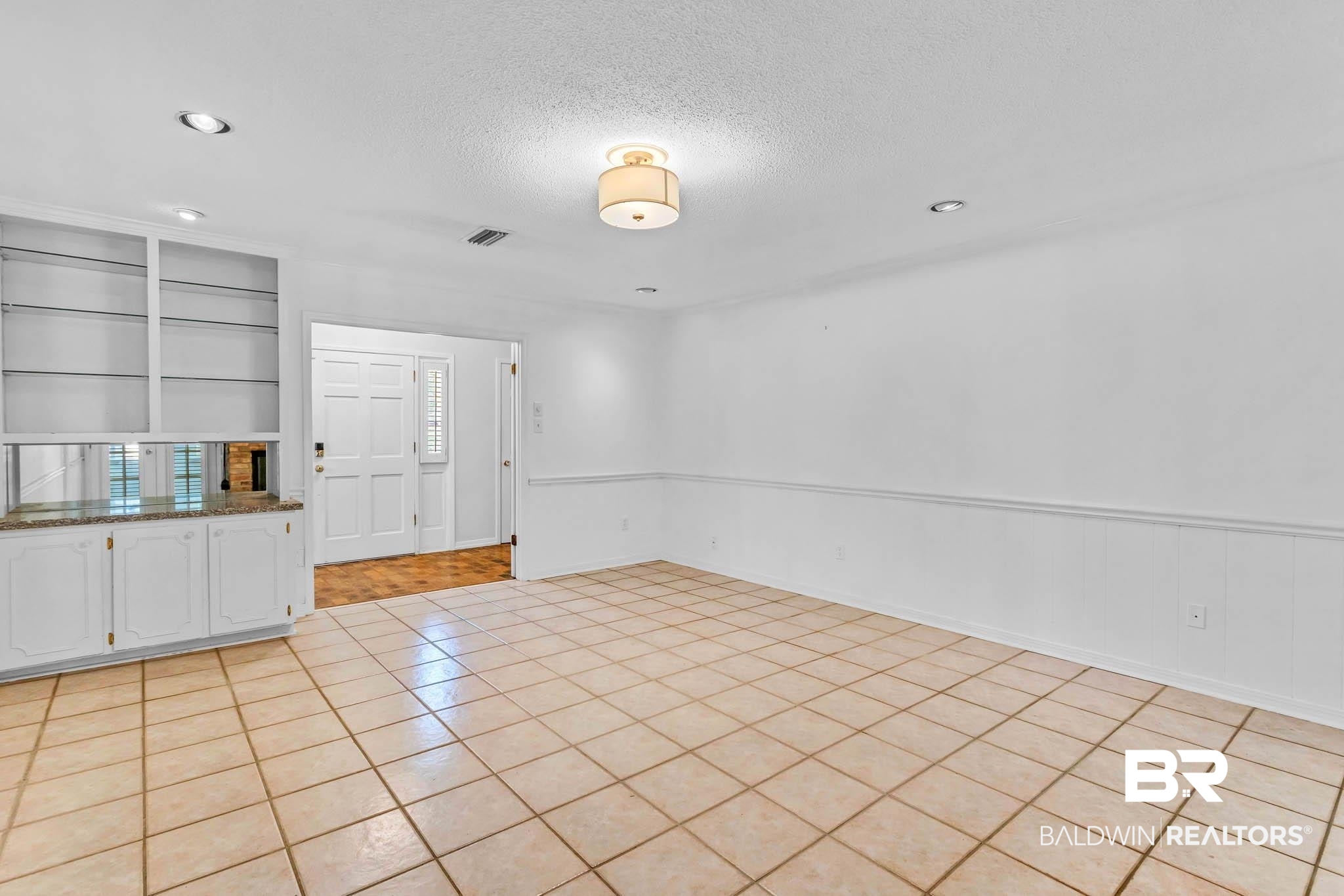 309 West Brandy Run Road Mobile, AL 36608 - Photo 13 of 100 Unfurnished room with light tile patterned floors, a textured ceiling, recessed lighting, and built in shelves