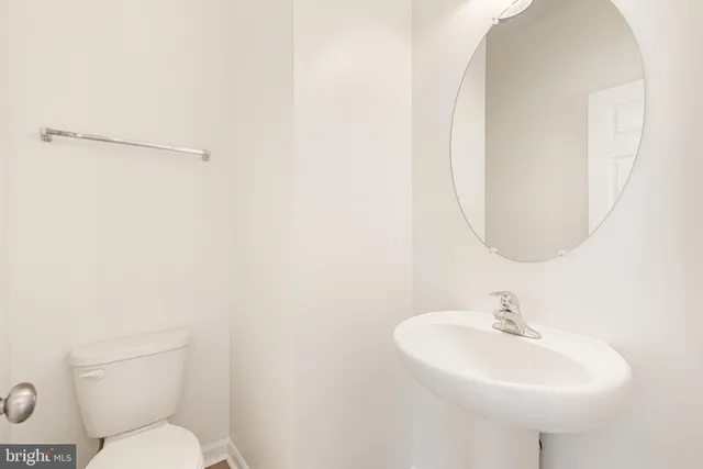 a bathroom with a sink a mirror and a toilet