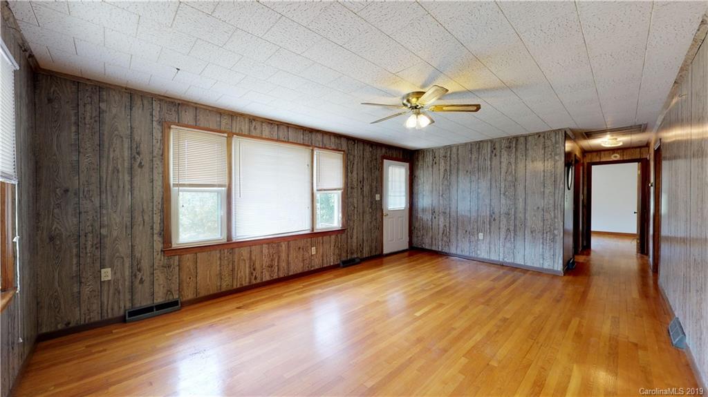 8617 Cruso Road Canton, NC 28716 - Photo 21 of 30 an empty room with wooden floor and windows
