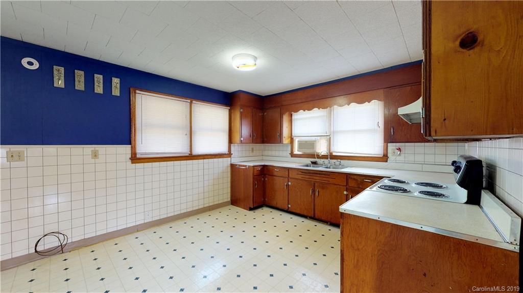 8617 Cruso Road Canton, NC 28716 - Photo 22 of 30 a kitchen with a sink a stove a refrigerator cabinets and a window