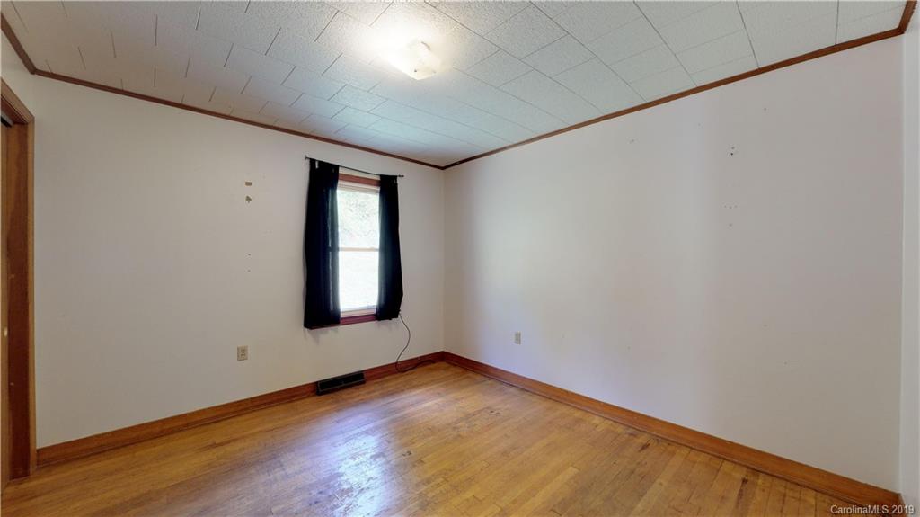 8617 Cruso Road Canton, NC 28716 - Photo 23 of 30 an empty room with wooden floor and windows