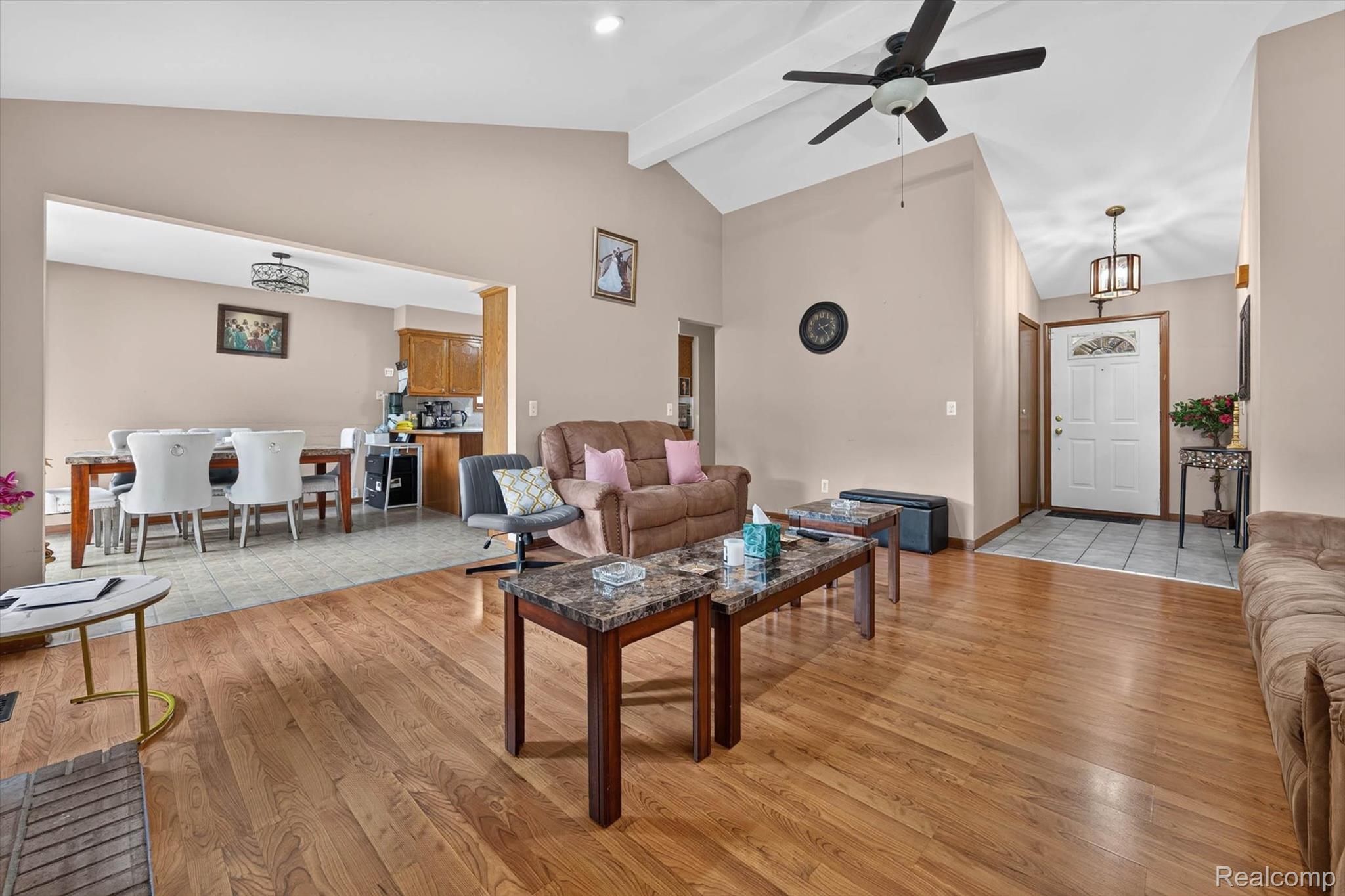 46362 Springhill Drive Utica, MI 48317 - Photo 9 of 59 Living area featuring wood-finish flooring, vaulted ceiling, and a ceiling fan