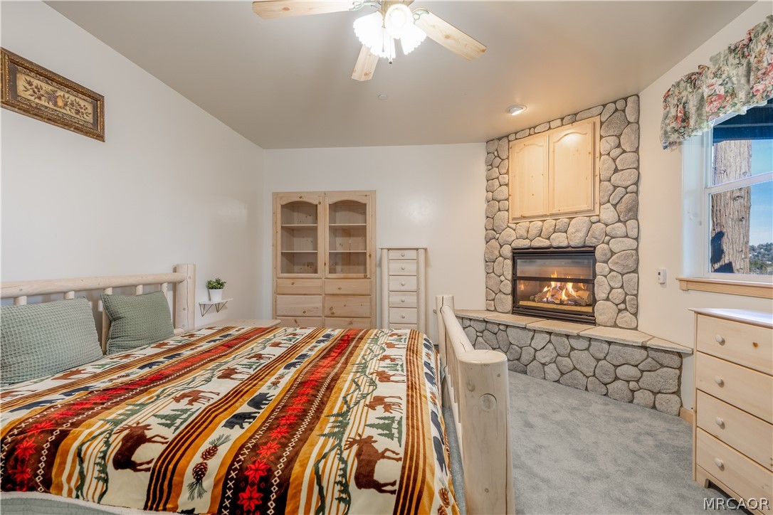 277 Grizzly Road Lake Arrowhead, CA 92352 - Photo 17 of 33 a bedroom with a bed and a fireplace