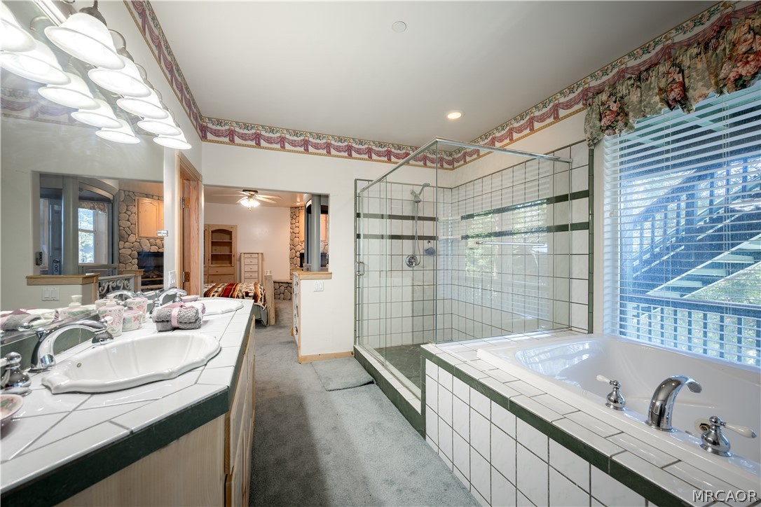 277 Grizzly Road Lake Arrowhead, CA 92352 - Photo 18 of 33 a spacious bathroom with a granite countertop sink mirror and shower