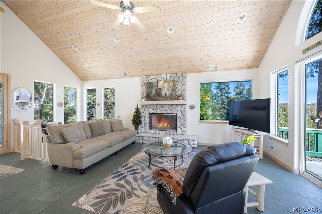 277 Grizzly Road Lake Arrowhead, CA 92352 - Photo 2 of 33 a living room with furniture a large window and a fireplace