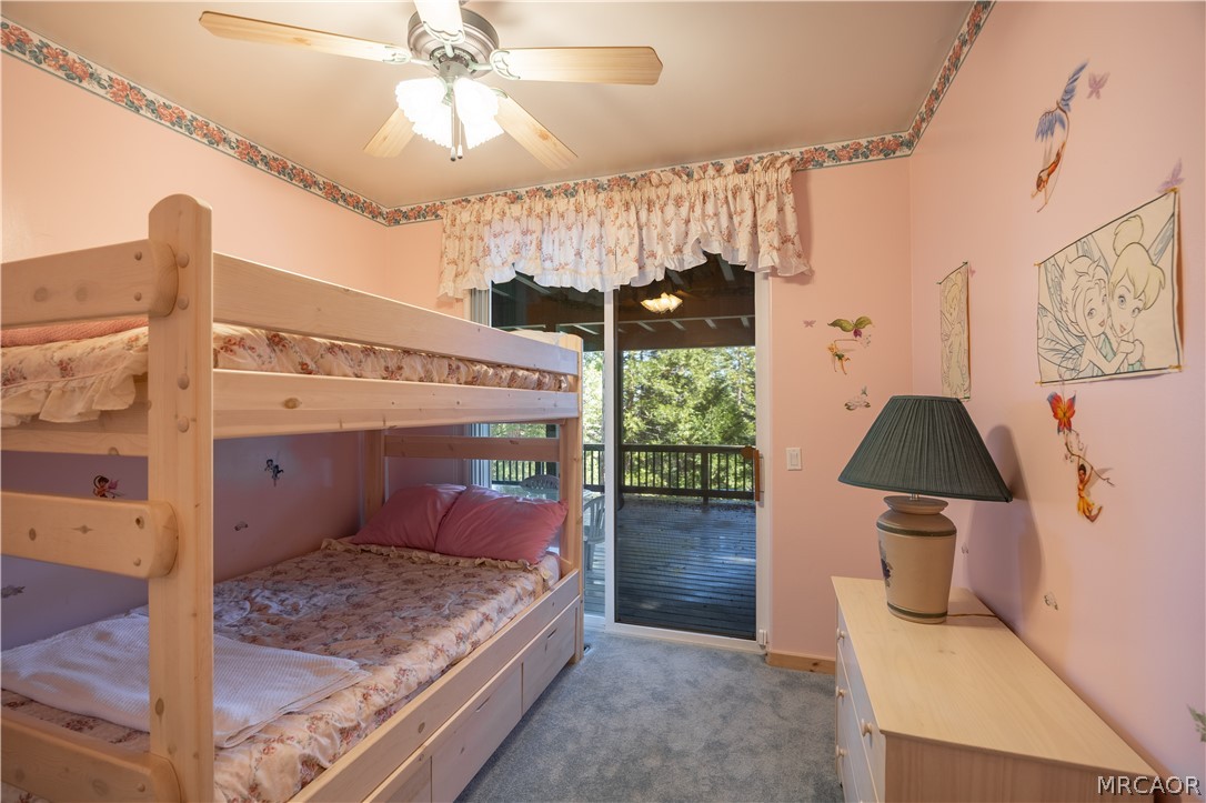 277 Grizzly Road Lake Arrowhead, CA 92352 - Photo 22 of 33 a bedroom with a bed and a chandelier
