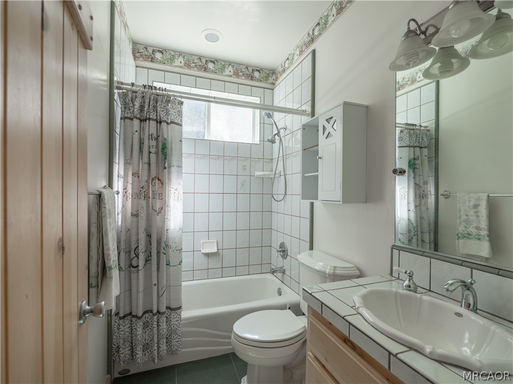 277 Grizzly Road Lake Arrowhead, CA 92352 - Photo 24 of 33 a bathroom with a granite countertop sink toilet and shower
