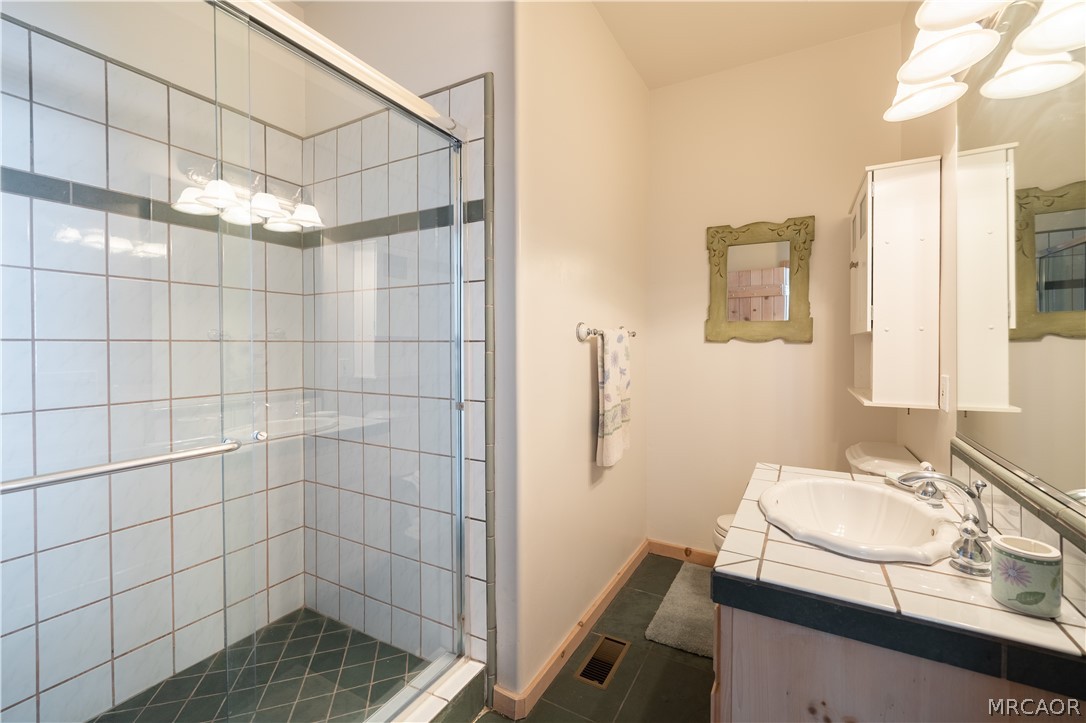 277 Grizzly Road Lake Arrowhead, CA 92352 - Photo 30 of 33 a bathroom with a sink shower and a mirror