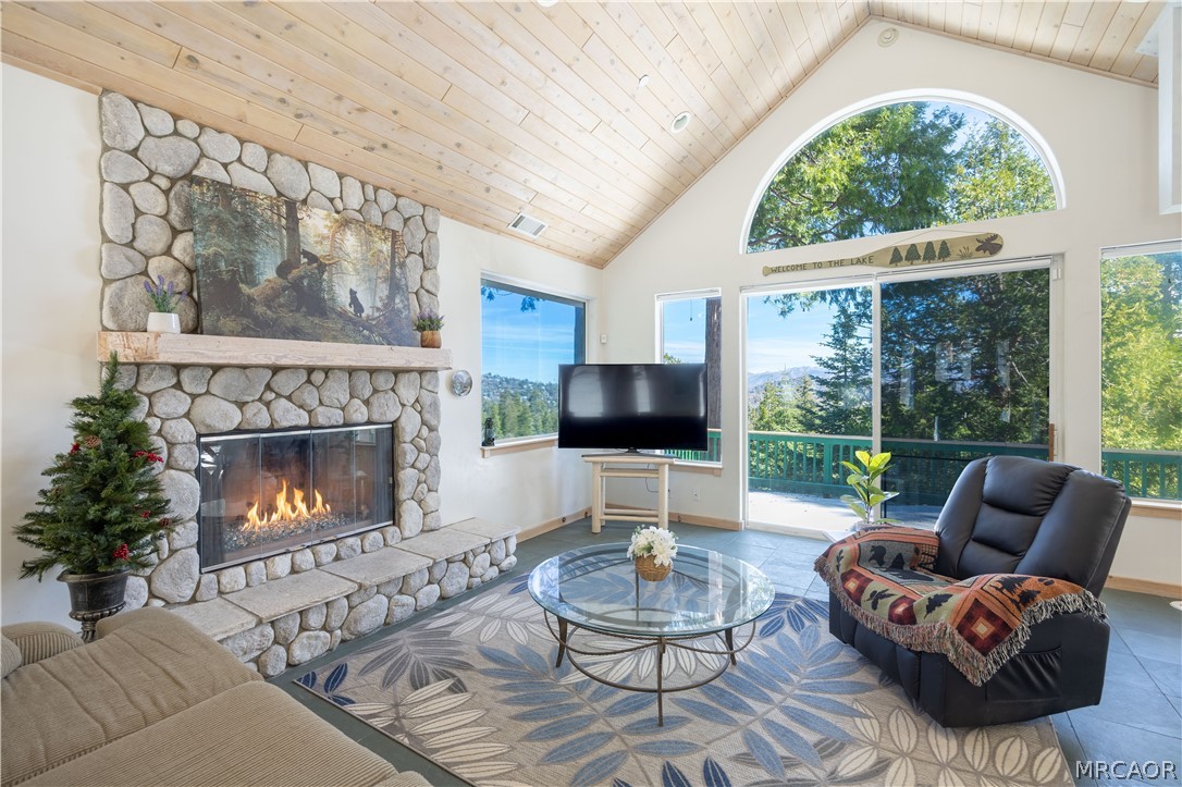 277 Grizzly Road Lake Arrowhead, CA 92352 - Photo 3 of 33 a living room with furniture a fireplace and a large window