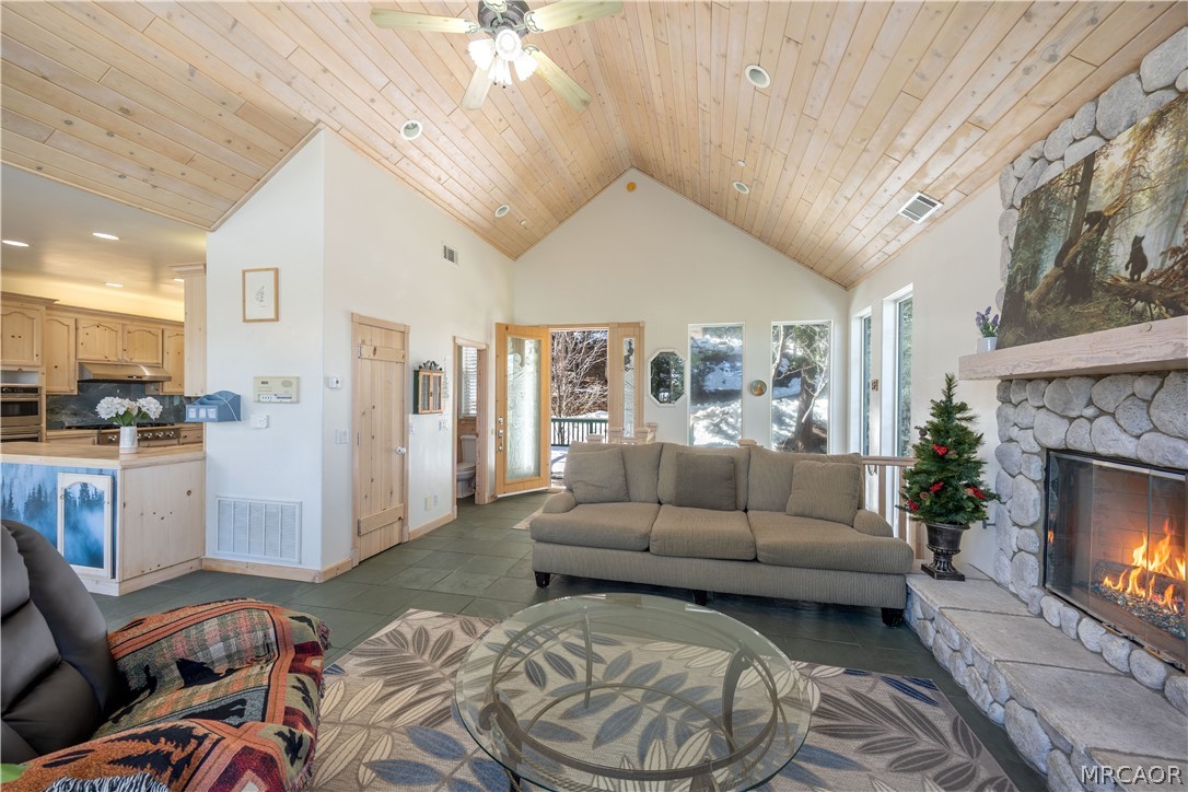 277 Grizzly Road Lake Arrowhead, CA 92352 - Photo 4 of 33 a living room with furniture and a fireplace