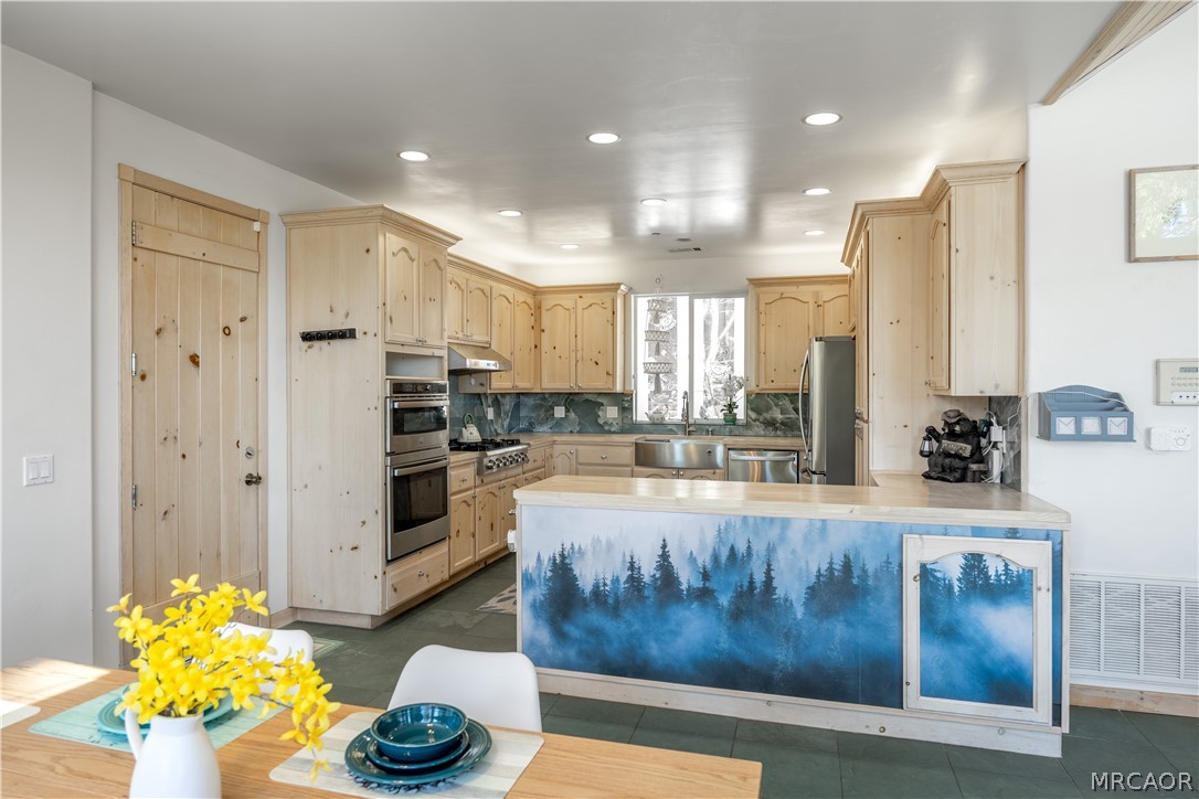 277 Grizzly Road Lake Arrowhead, CA 92352 - Photo 7 of 33 a large living room with stainless steel appliances granite countertop furniture and a fireplace