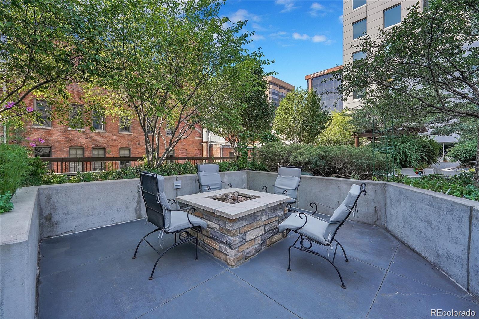 1625 Larimer Street, Unit 1007 Denver, CO 80202 - Photo 20 of 28 a view of a patio with a table and chairs