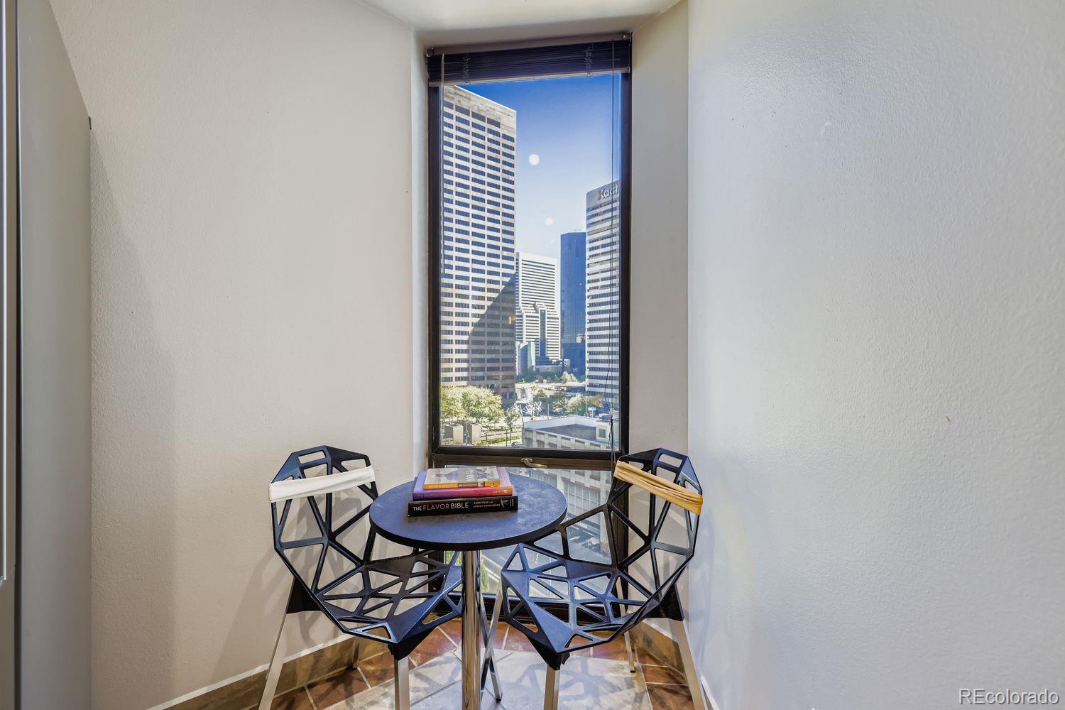 1625 Larimer Street, Unit 1007 Denver, CO 80202 - Photo 7 of 28 a view of a room that has a table and chairs