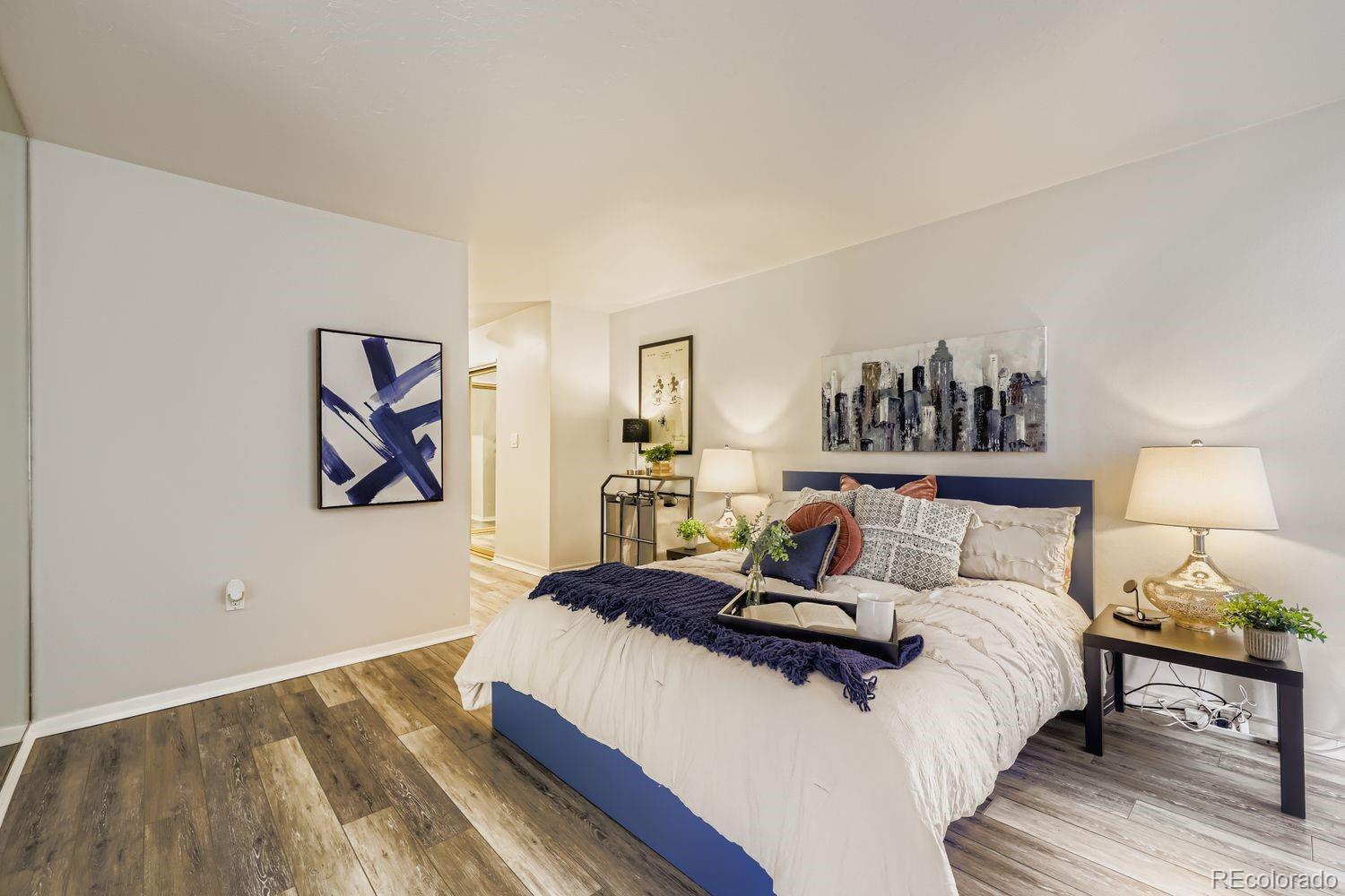 1625 Larimer Street, Unit 1007 Denver, CO 80202 - Photo 8 of 28 a bedroom with a bed and a painting on the wall