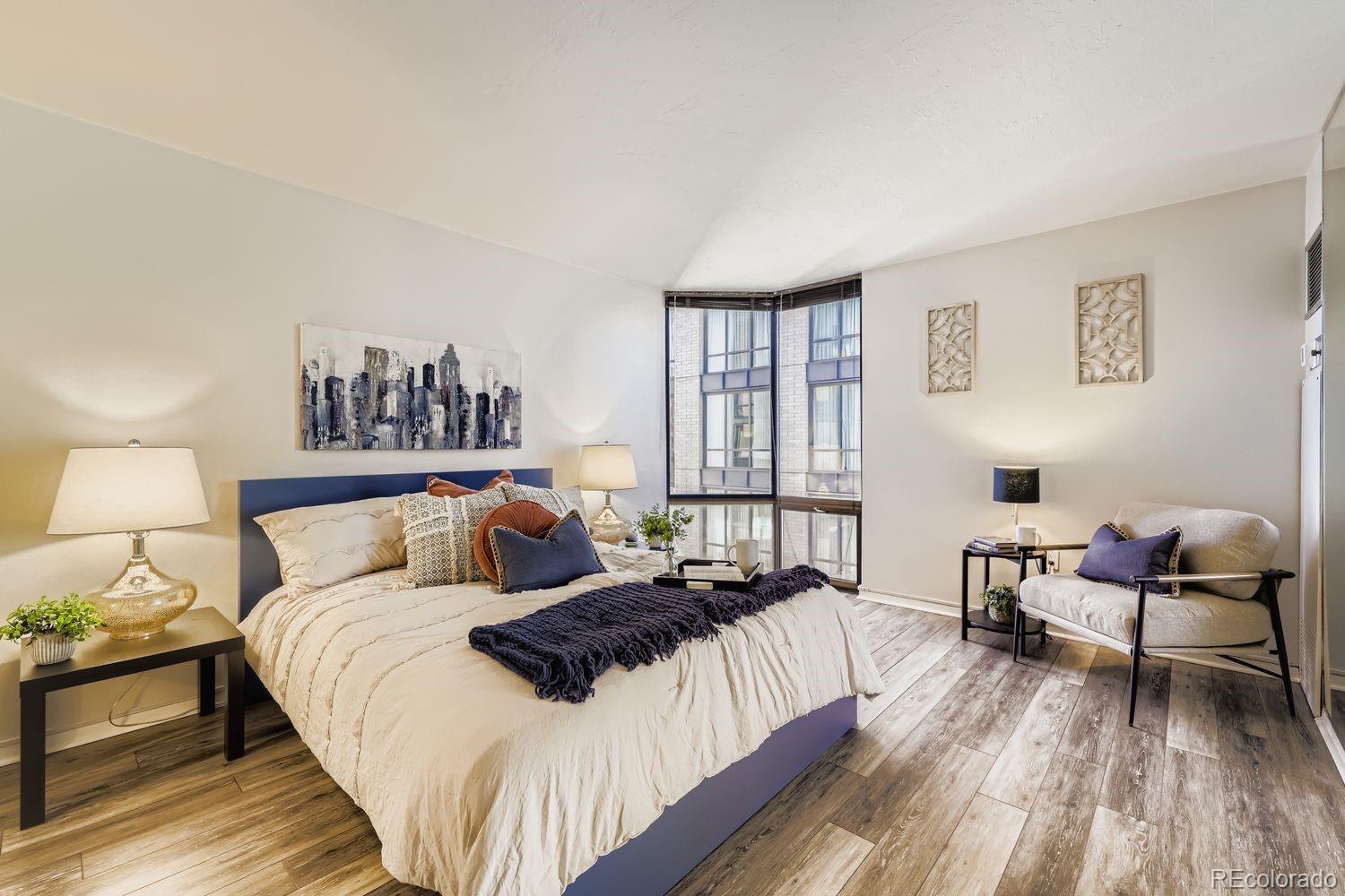 1625 Larimer Street, Unit 1007 Denver, CO 80202 - Photo 9 of 28 a bed room with two bed and a chair