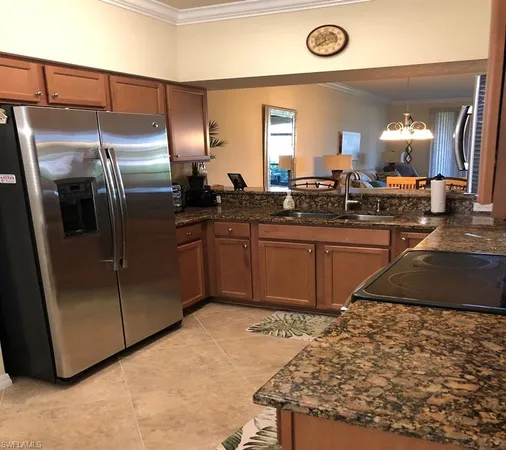 a kitchen with stainless steel appliances granite countertop a sink a stove and a refrigerator