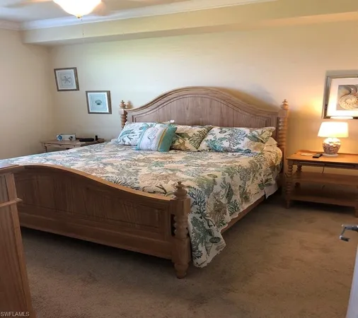 a bed sitting in a bedroom next to a lamp