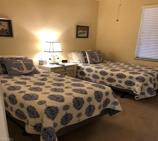 a bedroom with double bed and two lamp