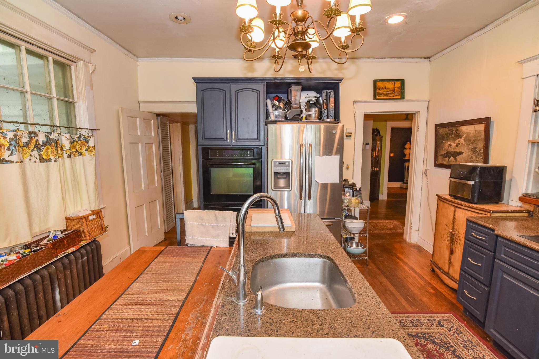 24 Merrymount Road Baltimore, MD 21210 - Photo 10 of 48 a bedroom with furniture and a wooden floor