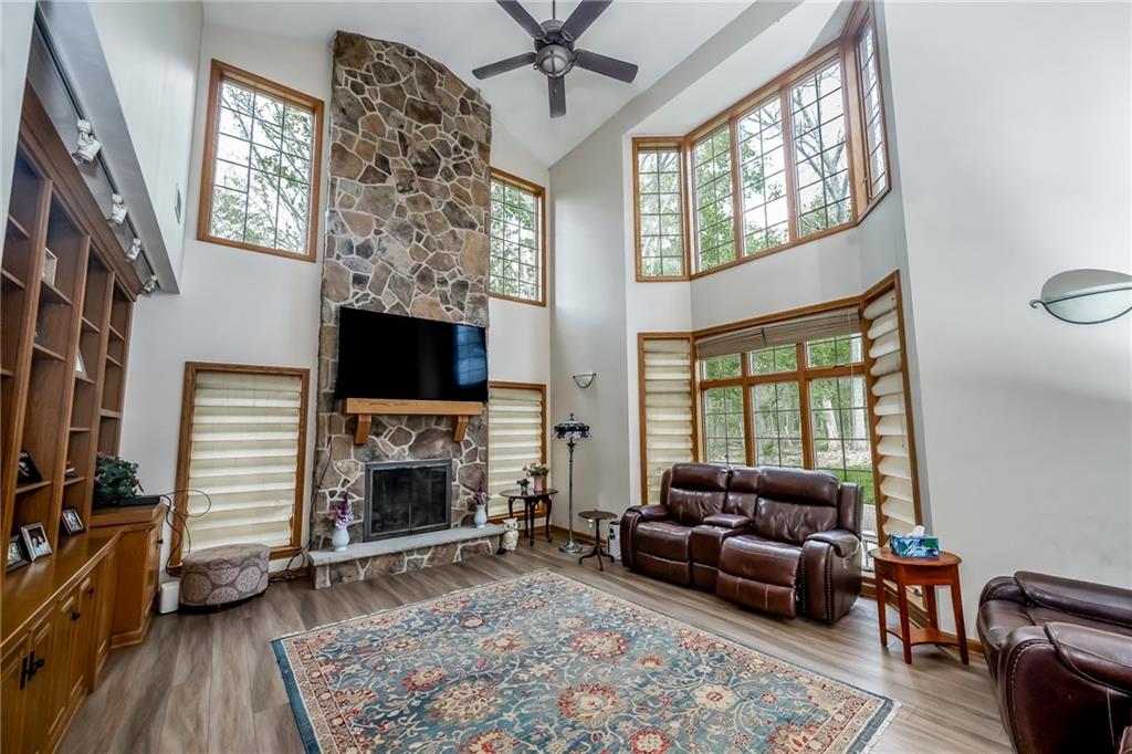 141 Timber Springs Drive Indiana, PA 15701 - Photo 25 of 50 a living room with furniture a fireplace a flat screen tv and a large window