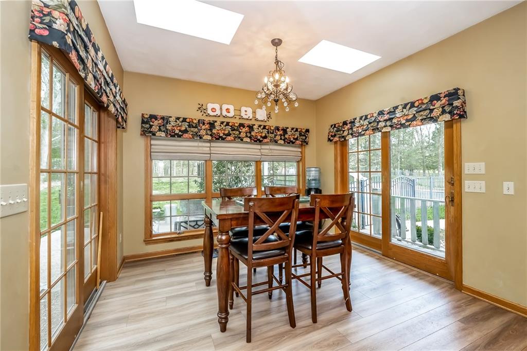 141 Timber Springs Drive Indiana, PA 15701 - Photo 31 of 50 a view of a dining room with furniture wooden floor and chandelier