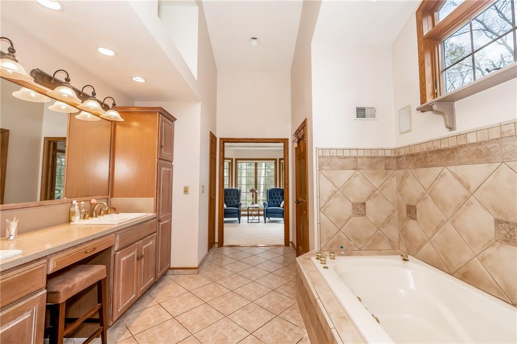 141 Timber Springs Drive Indiana, PA 15701 - Photo 41 of 50 a bathroom with a tub a sink and a large mirror