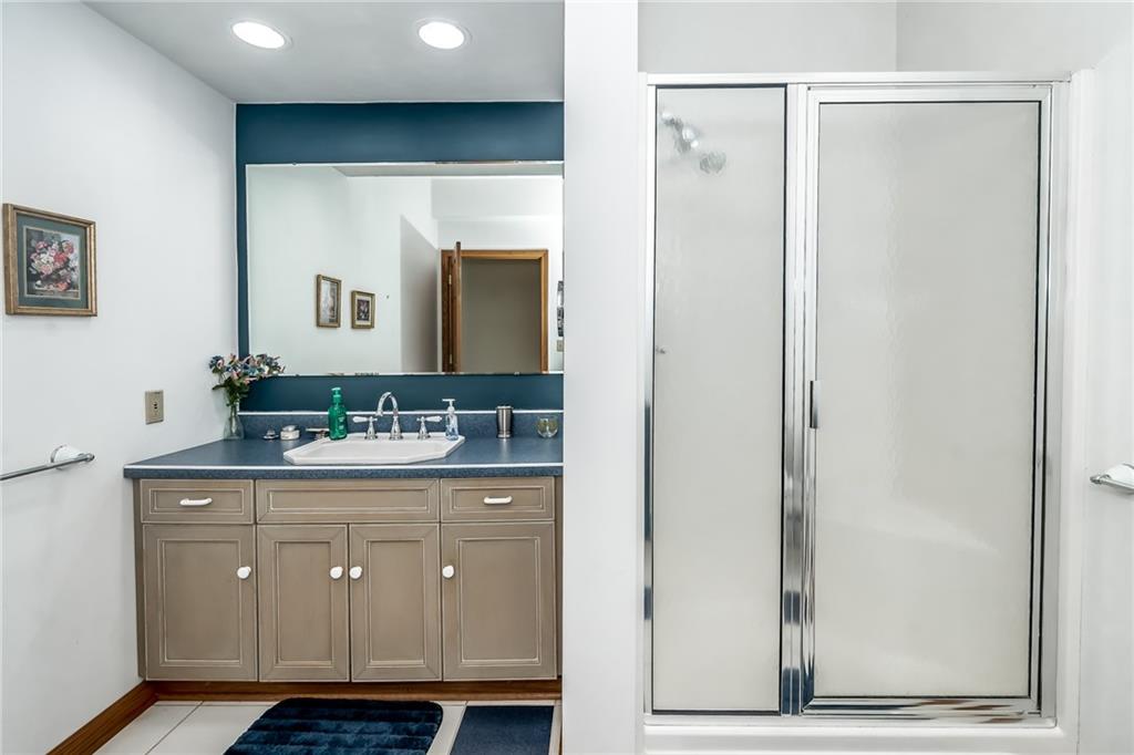 141 Timber Springs Drive Indiana, PA 15701 - Photo 50 of 50 a bathroom with a granite countertop sink a mirror and a shower