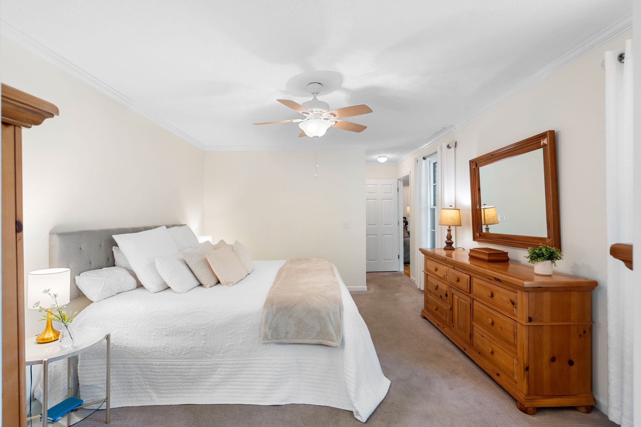 215 Devrow Court Franklin, TN 37064 - Photo 20 of 46 a spacious bedroom with a bed and a chandelier