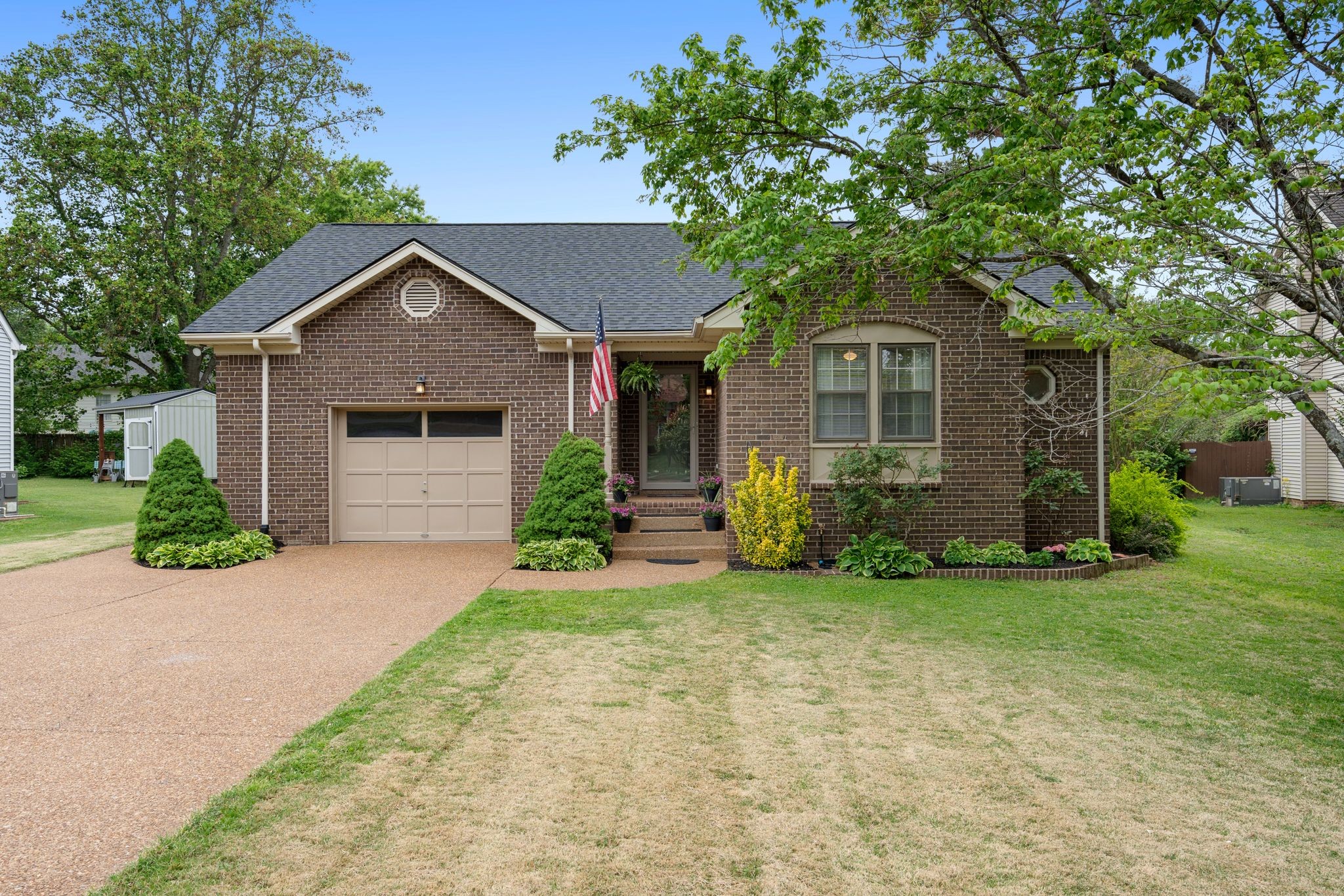 215 Devrow Court Franklin, TN 37064 - Photo 3 of 46 a front view of a house with a garden and yard