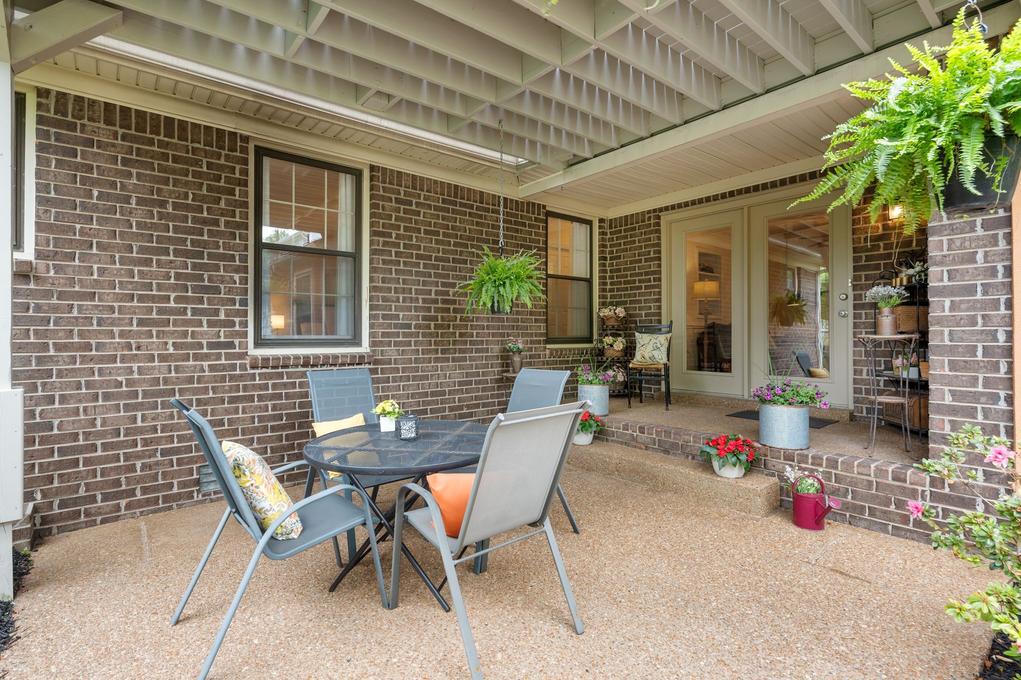 215 Devrow Court Franklin, TN 37064 - Photo 37 of 46 a view of a patio with table and chairs and potted plants