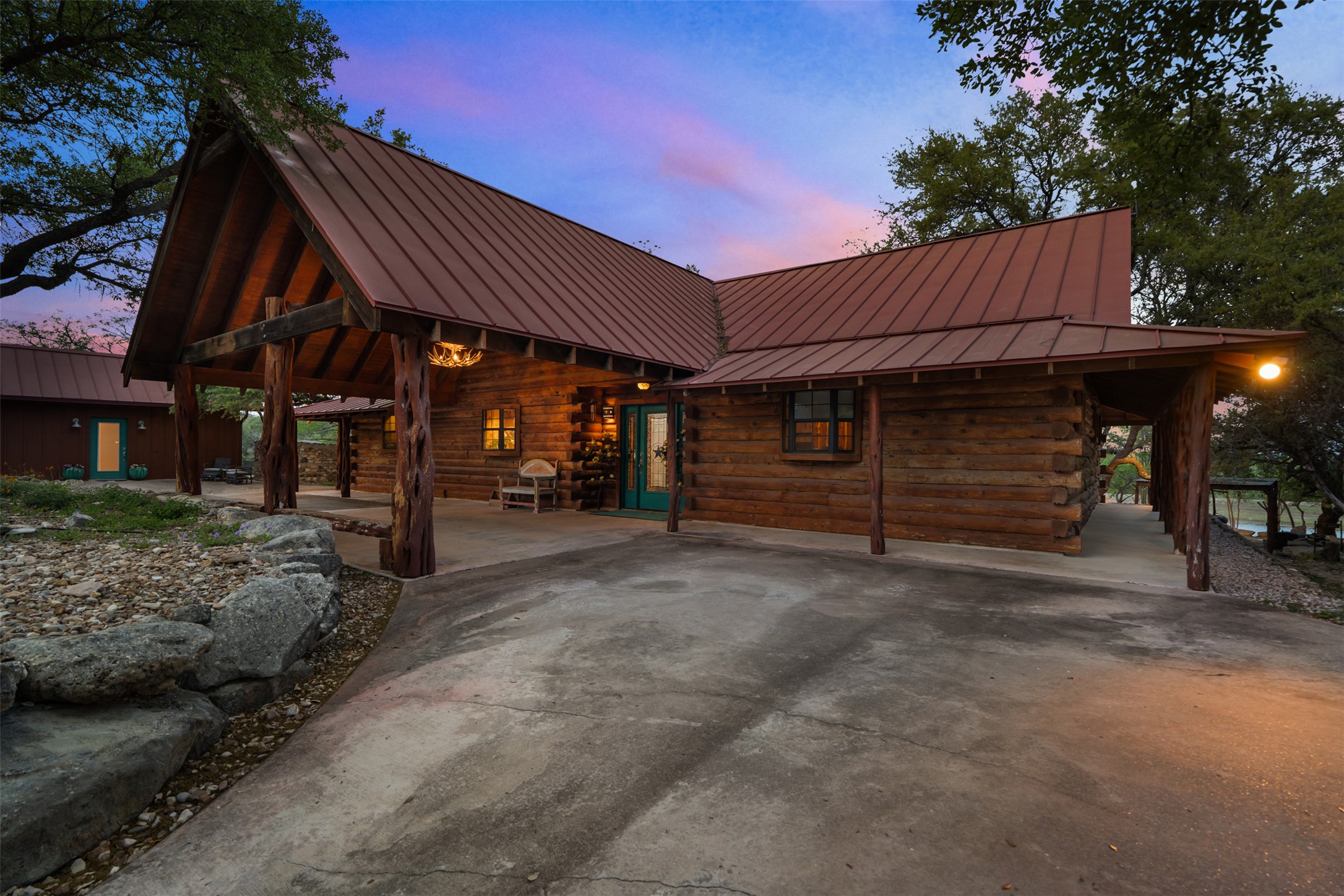 421 Rolling Hills Road Blanco, TX 78606 - Photo 21 of 40 Main guest log-home sitting alongside the lake.