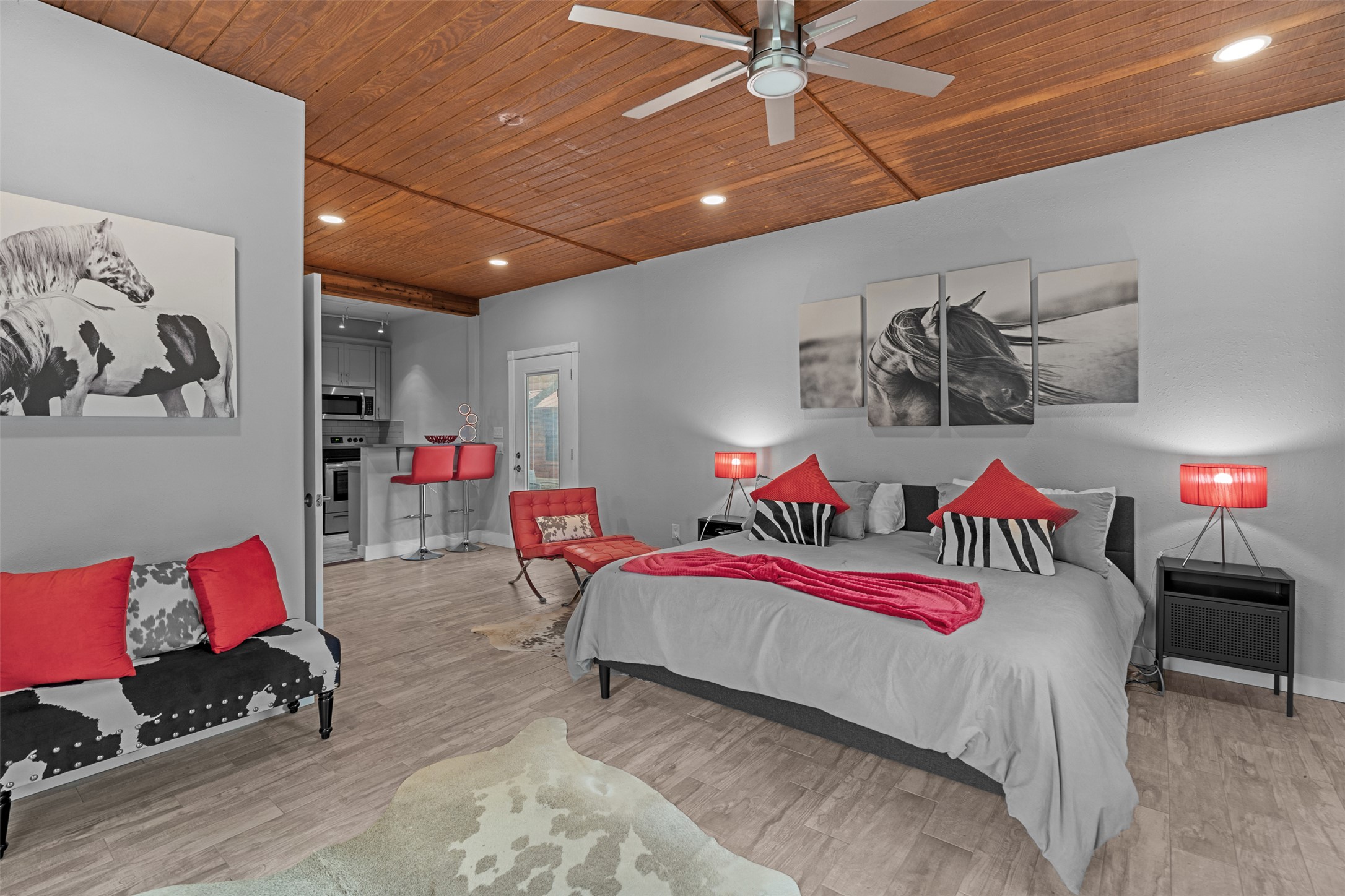 421 Rolling Hills Road Blanco, TX 78606 - Photo 32 of 40 This open-concept room features a wood plank ceiling and light-colored flooring.