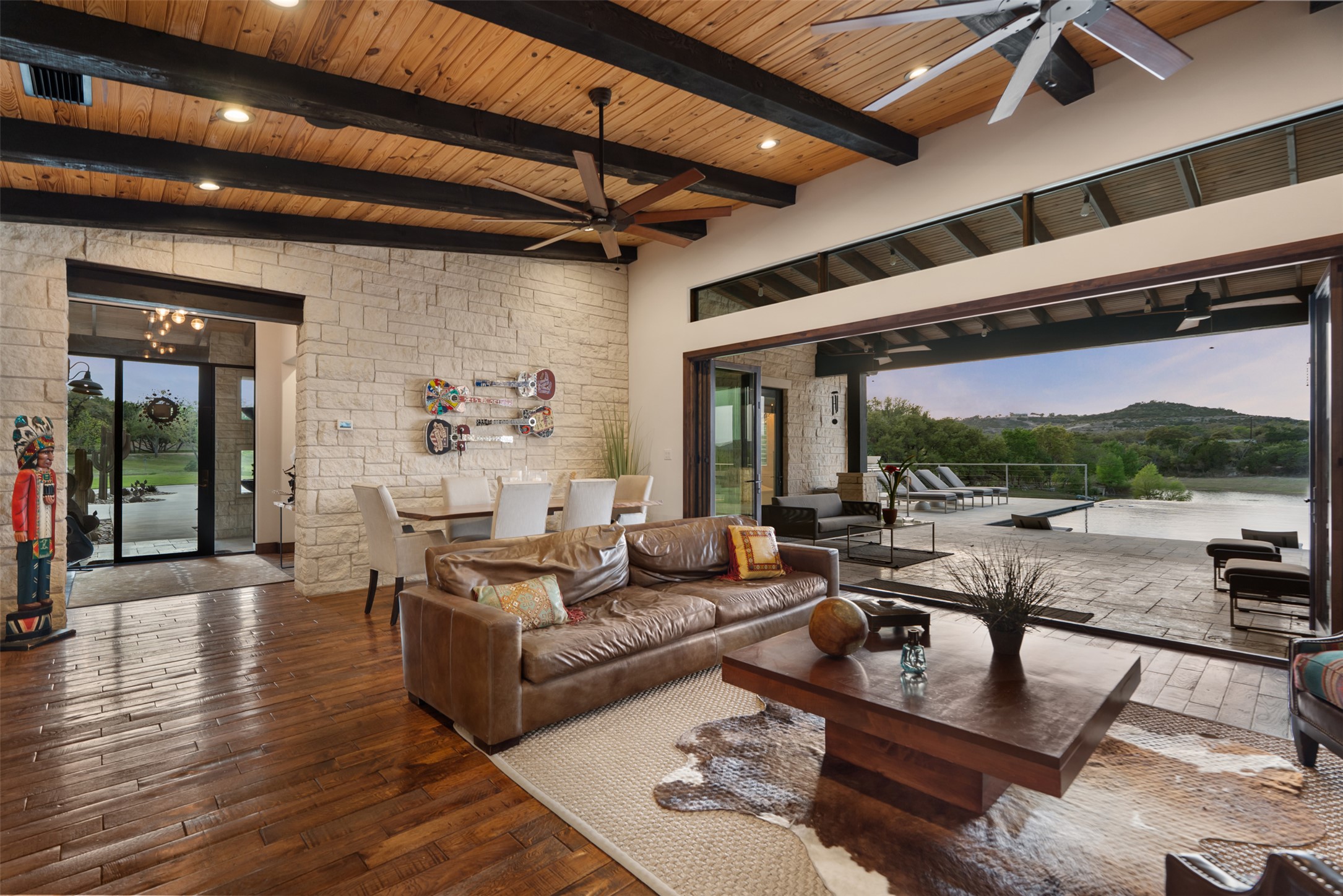 421 Rolling Hills Road Blanco, TX 78606 - Photo 4 of 40 Main living area with sliding glass doors opening up to the back patio and infinity pool.