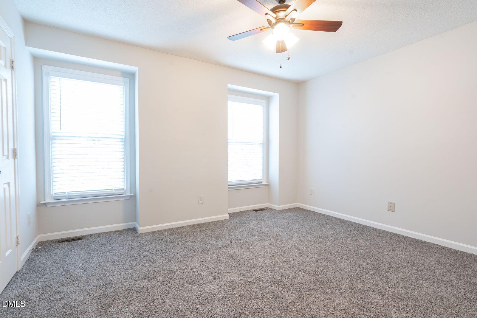 4418 Roller Court Raleigh, NC 27604 - Photo 11 of 13 an empty room with a window and a fan