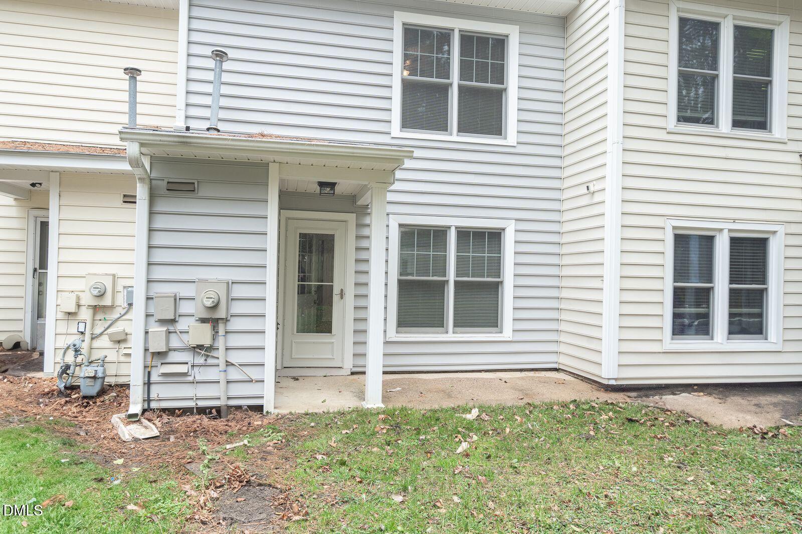 4418 Roller Court Raleigh, NC 27604 - Photo 13 of 13 a view of a house with a small yard and a large window