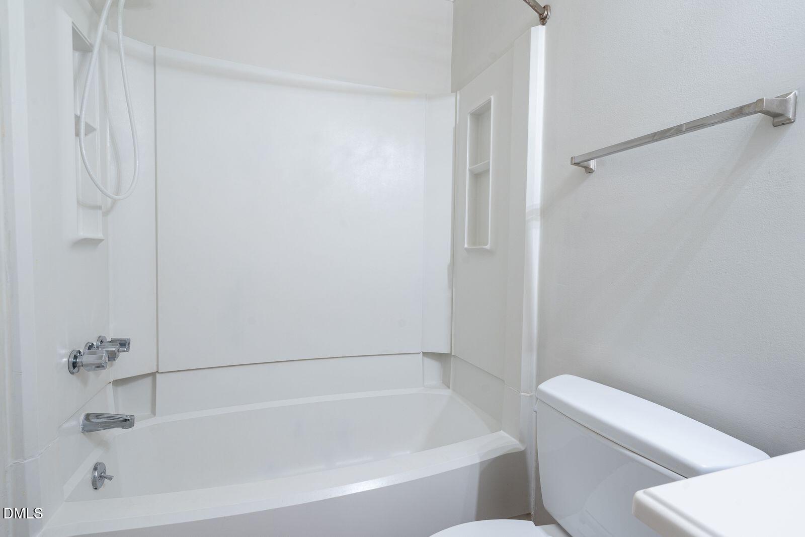 4418 Roller Court Raleigh, NC 27604 - Photo 10 of 13 a white bath tub with a toilet