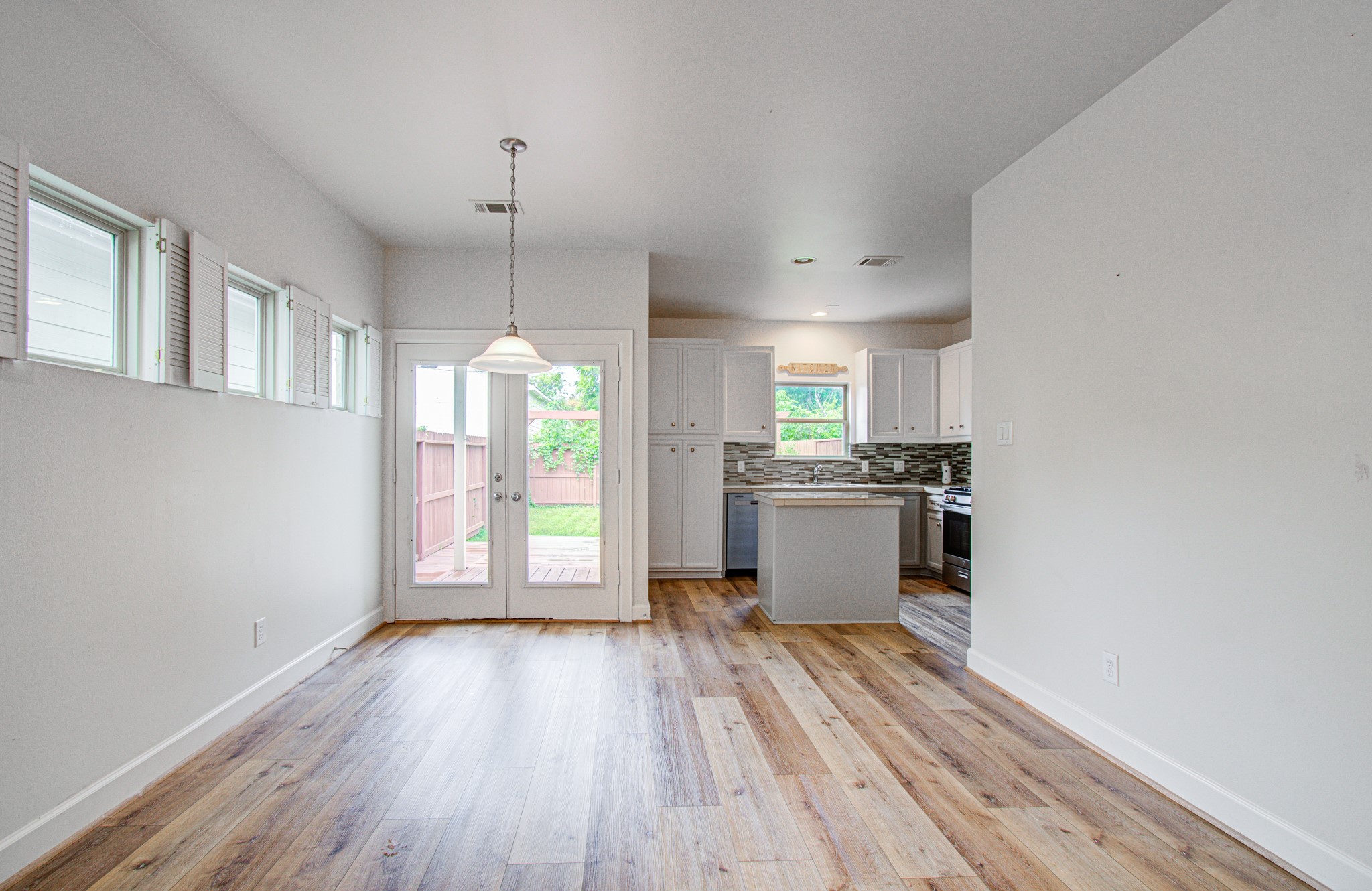624 East 39th Street Houston, TX 77022 - Photo 11 of 37 a kitchen with granite countertop a stove cabinets and wooden floor