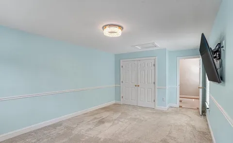 an empty room with windows and closet