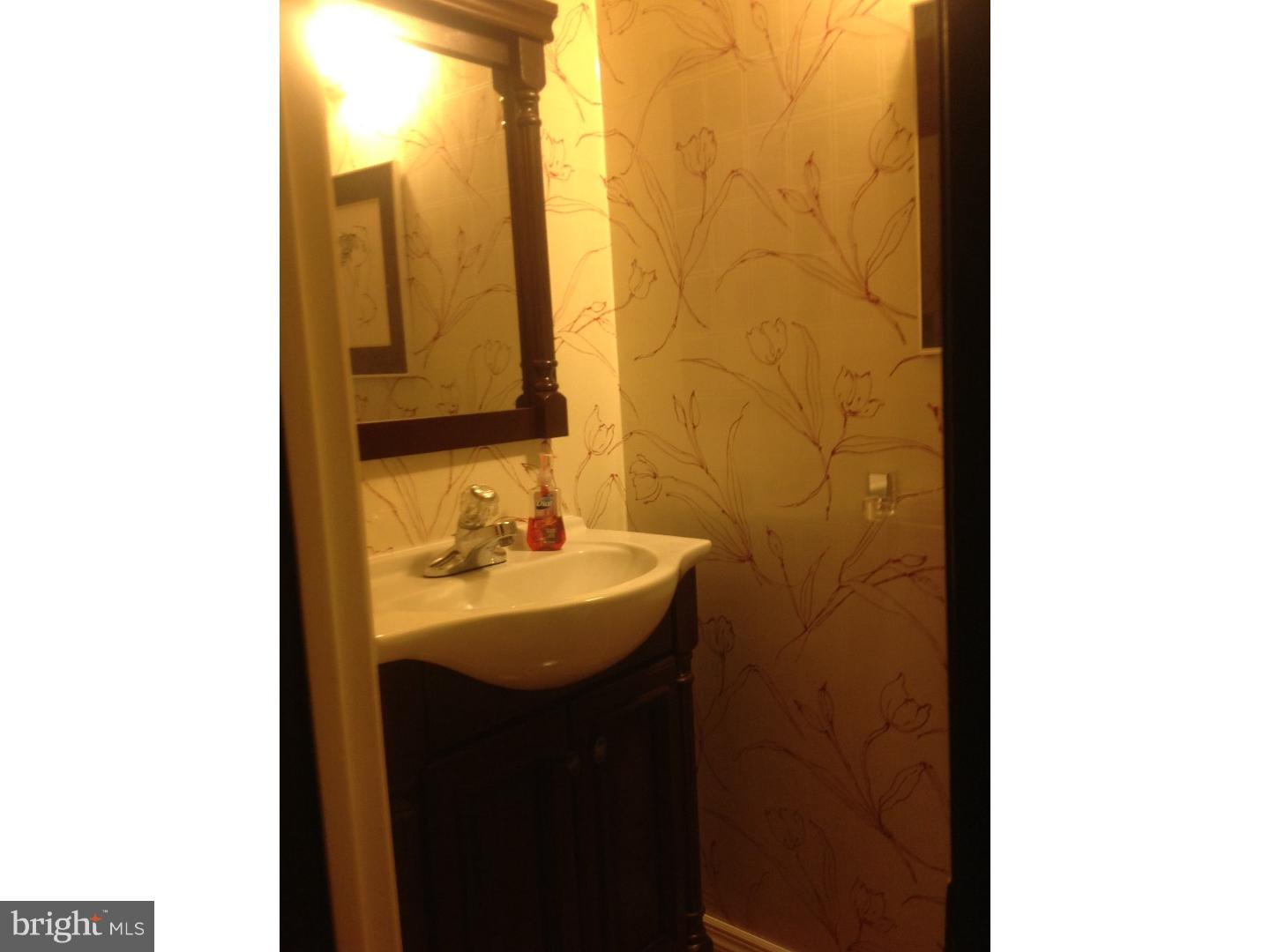 9708 Glenhope Road Philadelphia, PA 19115 - Photo 11 of 25 a bathroom with a sink and a mirror