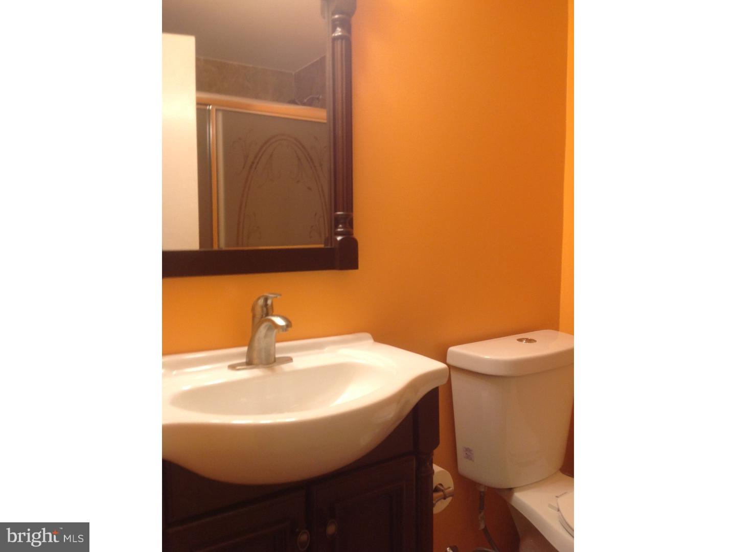 9708 Glenhope Road Philadelphia, PA 19115 - Photo 14 of 25 a bathroom with a sink a toilet and mirror