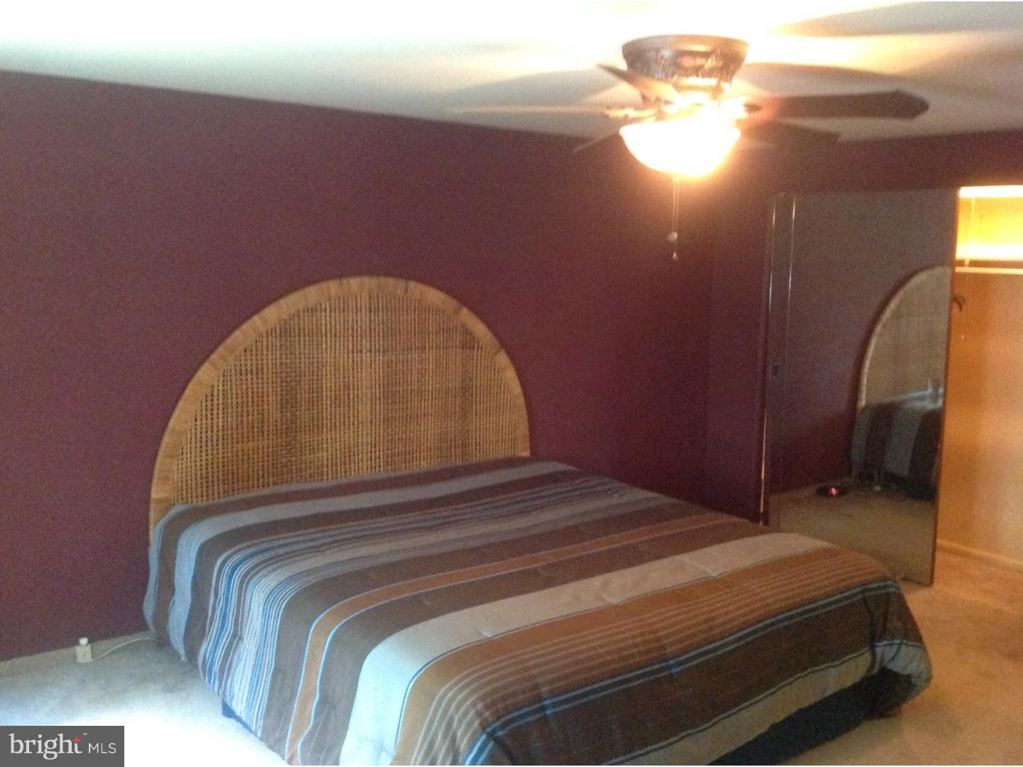 9708 Glenhope Road Philadelphia, PA 19115 - Photo 15 of 25 a bedroom with a bed and a chandelier