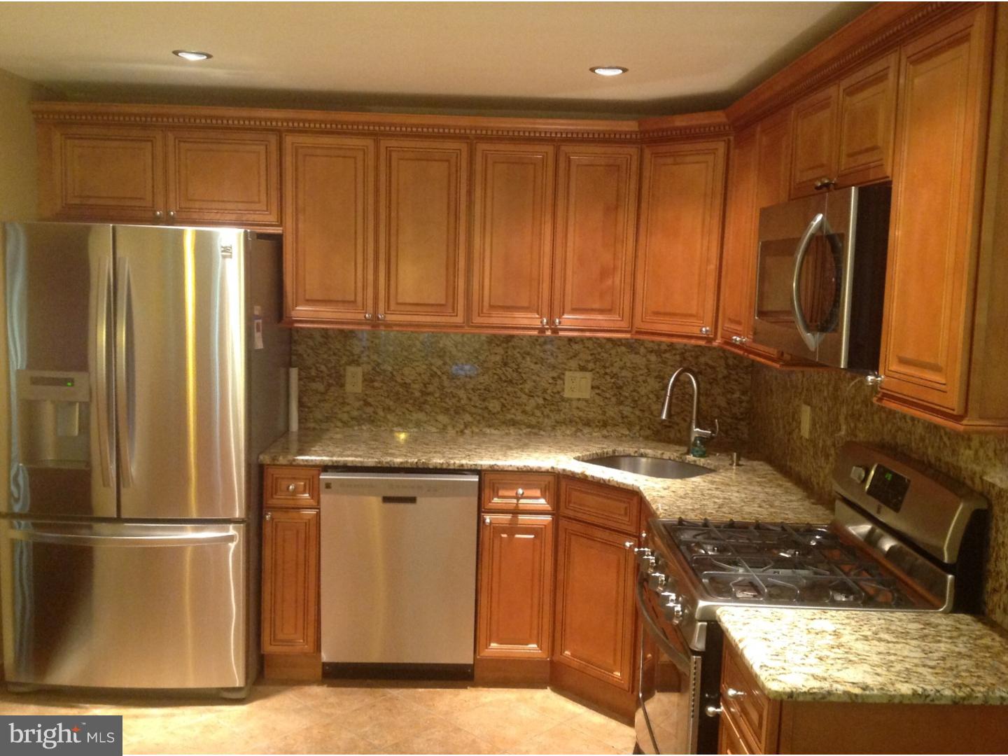 9708 Glenhope Road Philadelphia, PA 19115 - Photo 6 of 25 a kitchen with stainless steel appliances granite countertop a refrigerator a stove and a sink