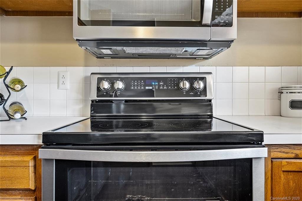 232 Queens Road, Unit 39 Charlotte, NC 28204 - Photo 12 of 29 a stove top oven sitting inside of a kitchen